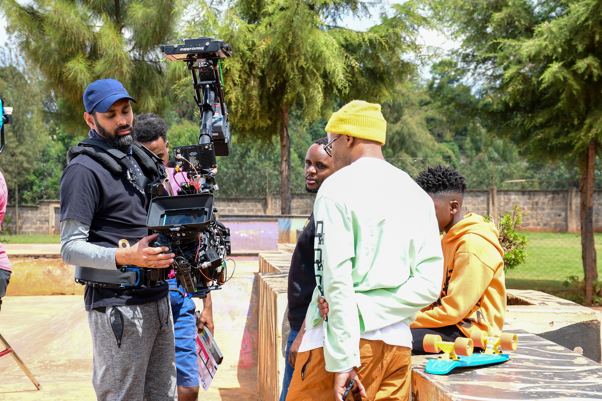Cinema camera operator filming on location in Kenya