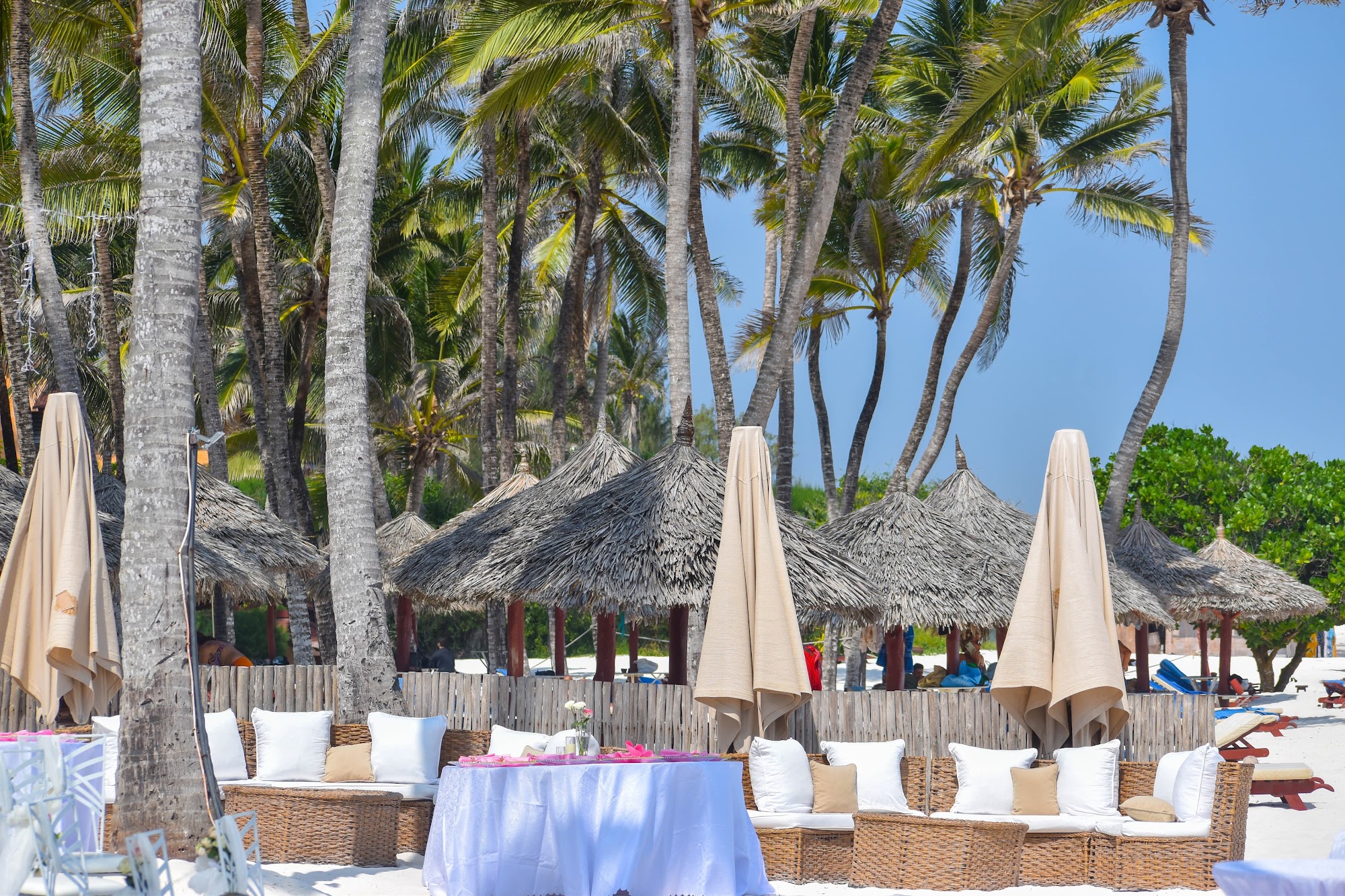 Beach wedding reception setup under palm trees in Kenya